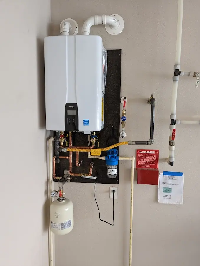 Professional plumber installing copper piping in a Gretna home